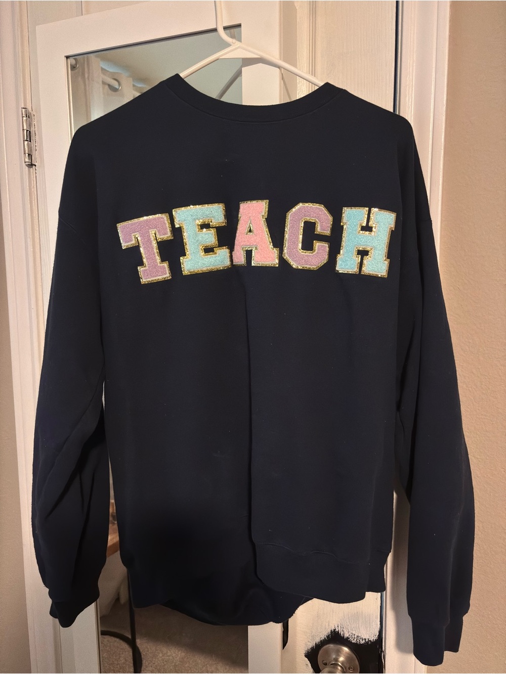 Navy Crewneck Sweatshirt with Pastel 'TEACH' Appliqué